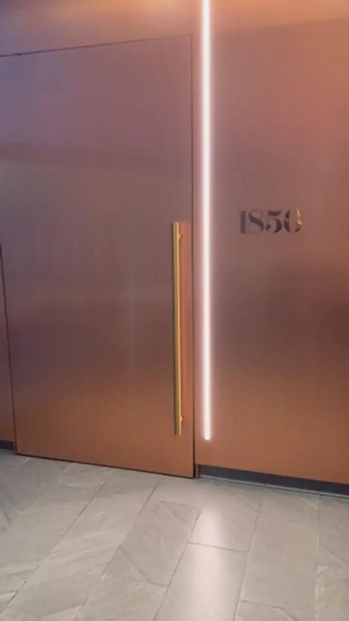 The copper door marked 1850 at the Centurion Lounge JFK